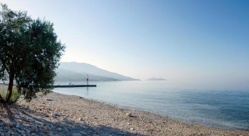 Ormos of Koumaeika, Samos, with traditional fishing boats and calm waters.