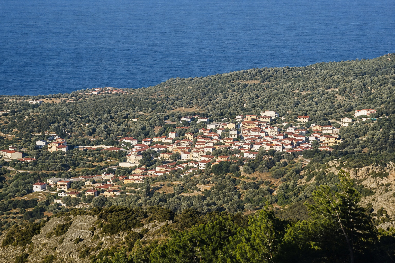 View from Koumaeika village in Samos with traditional houses and the Aegean horizon.