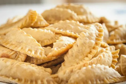 Traditional Samian skaltsounia with powdered sugar and cinnamon
