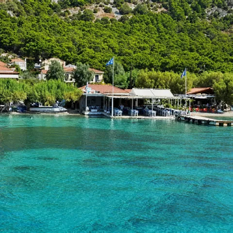 Poseidonio Bay in Samos with calm waters, seaside tavernas and views of Asia Minor