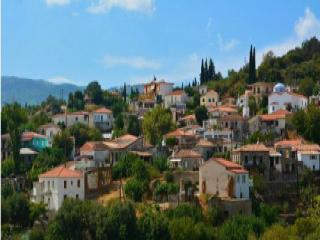 Il villaggio Koumaradaioi a Samo con case in pietra e vista verso la costa meridionale.